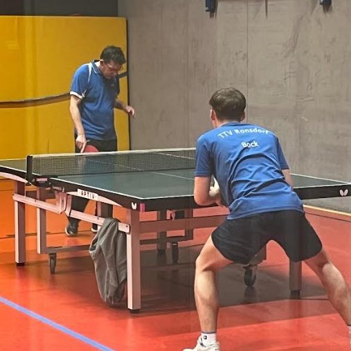 Gruppe von Jugendlichen in blauen Sportshirts vor einem Tischtenniszentrum. Gruppe von Jugendlichen in blauen Sportshirts vor einem Tischtenniszentrum.
